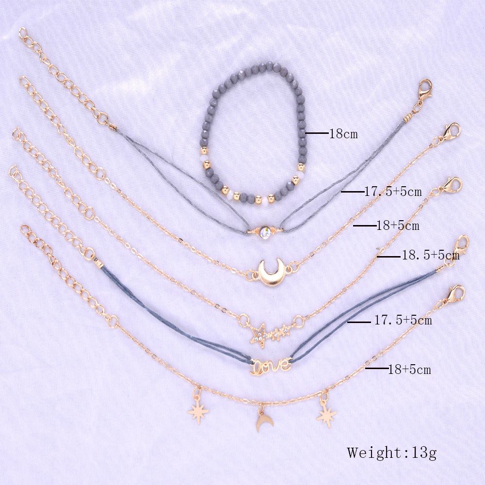 Set of gold necklaces with various pendants on a light purple background