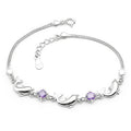 Silver bracelet with purple gemstones on a white background