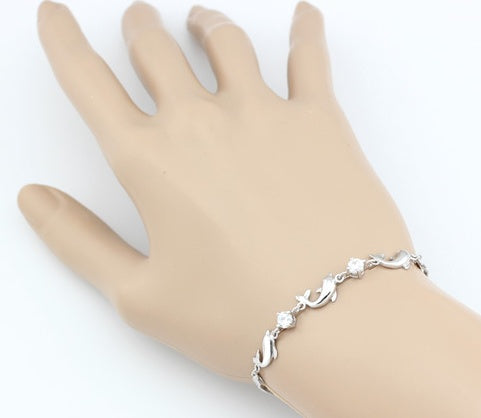 Silver bracelet on a mannequin hand against a white background