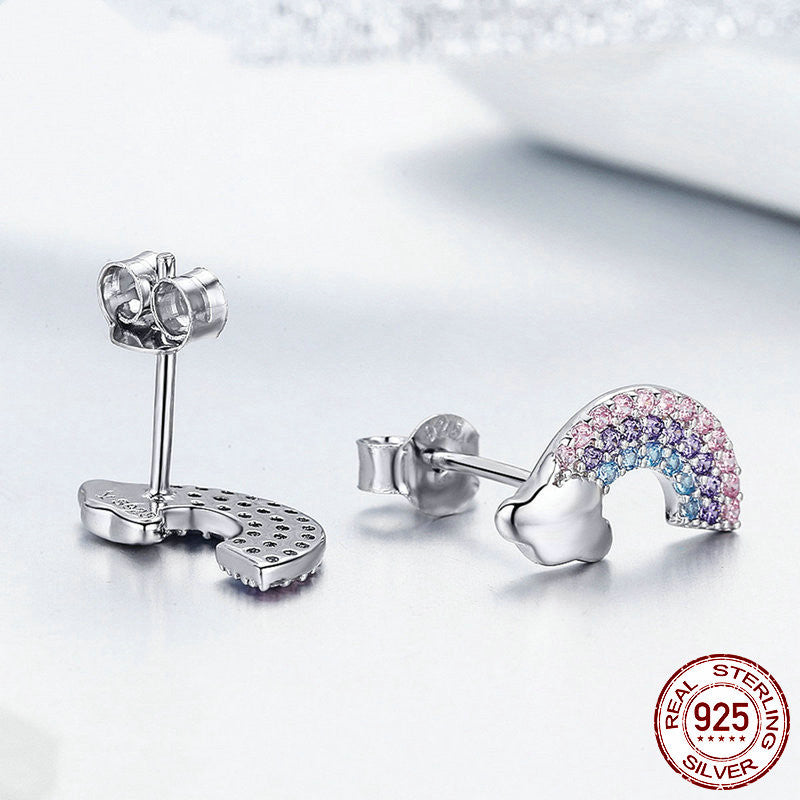 Silver earrings with colorful gemstones on a light background