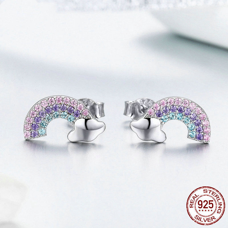 Rainbow-shaped earrings with a silver base on a light gray background, featuring a '925 Sterling Silver' stamp.