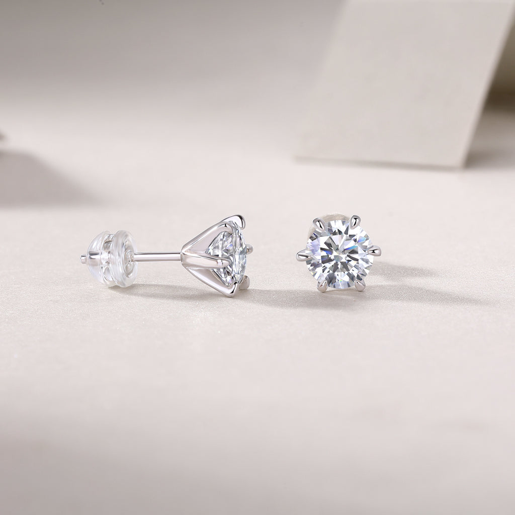 Pair of diamond stud earrings on a light gray background