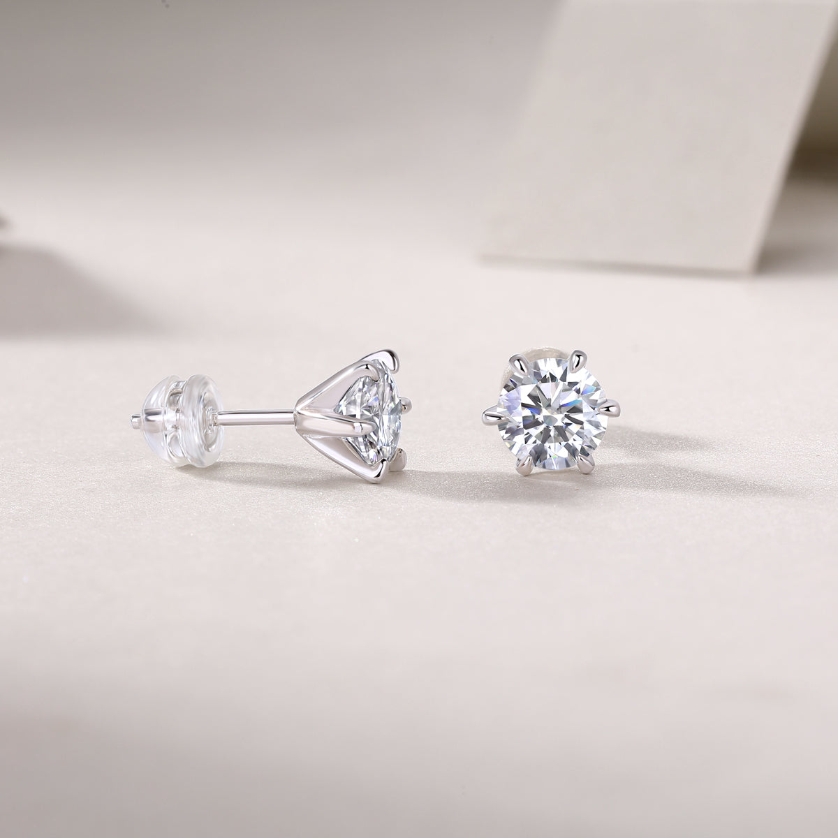 Pair of diamond stud earrings on a light gray background
