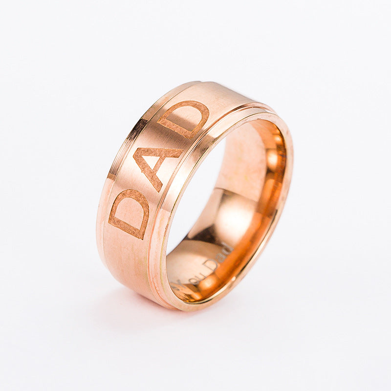 Rose gold ring with 'DAD' engraving on a white background