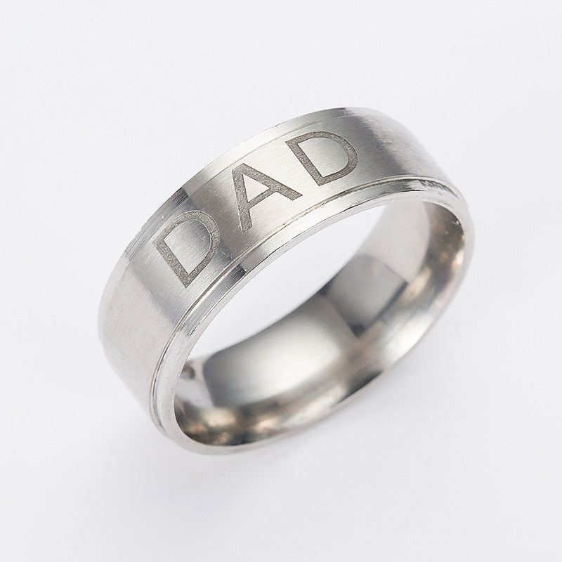 Silver ring with 'DAD' engraving on a white background