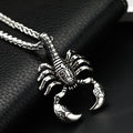 Silver scorpion pendant necklace on a dark textured surface