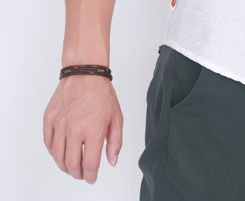 Person wearing a bracelet on a plain background