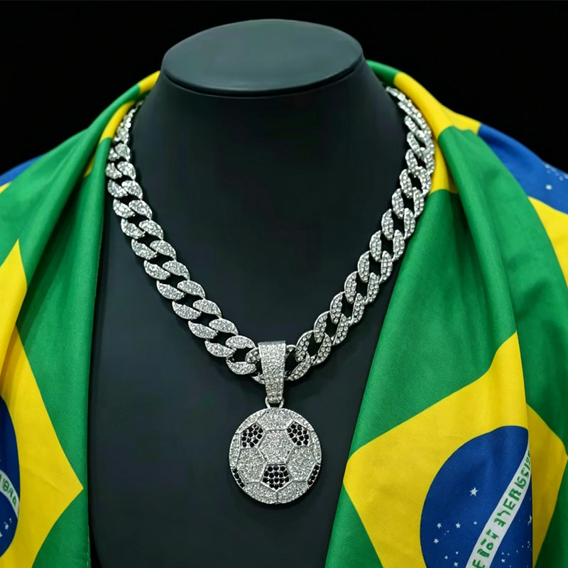 Silver chain necklace with a soccer ball pendant on a mannequin draped with a Brazilian flag.